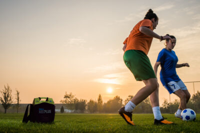 two female soccer players on the field